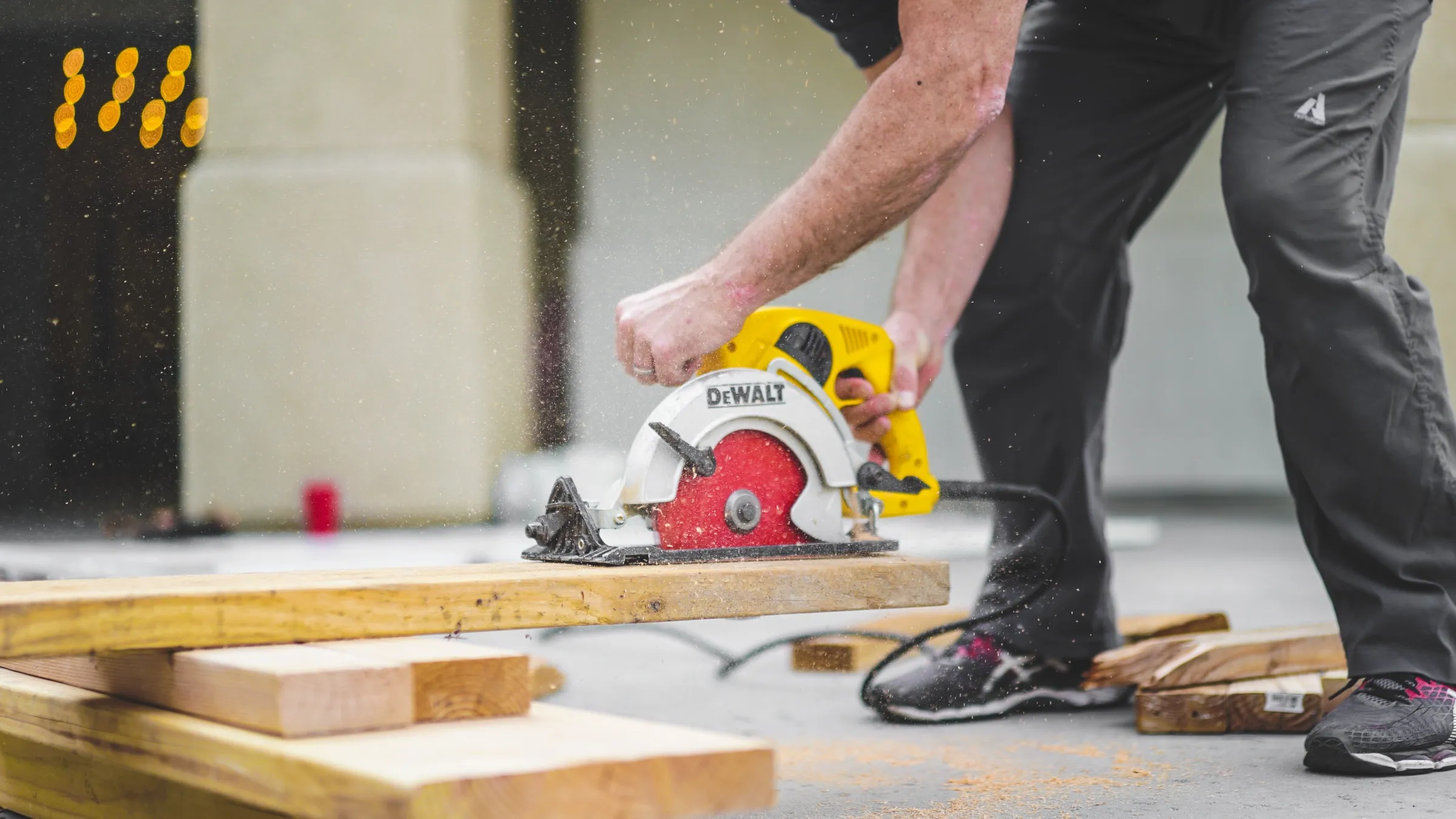 man cutting plank with circular